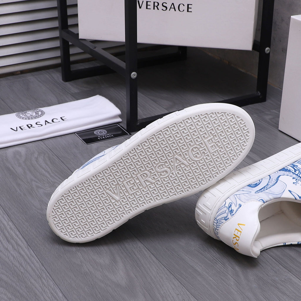 White Versace sneakers with blue uppers; textured outsole with repeating pattern.