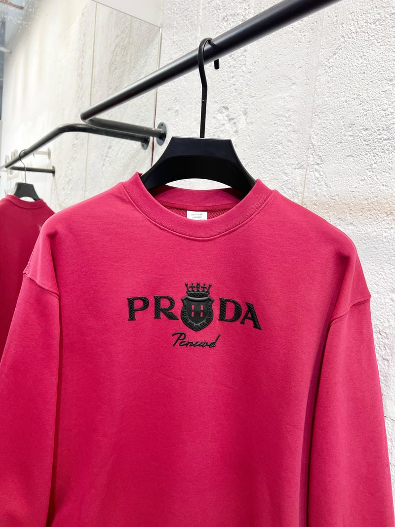 Pink crewneck sweatshirt with PRADA logo and crown graphic