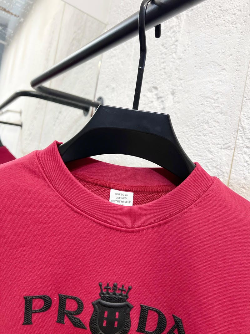 Pink crewneck sweatshirt neckline with embroidered PRADA crown graphic