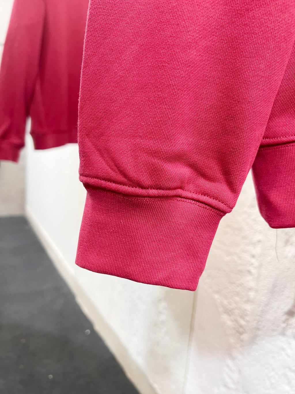 Pink sweatshirt sleeve cuff and hem, ribbed knit detail