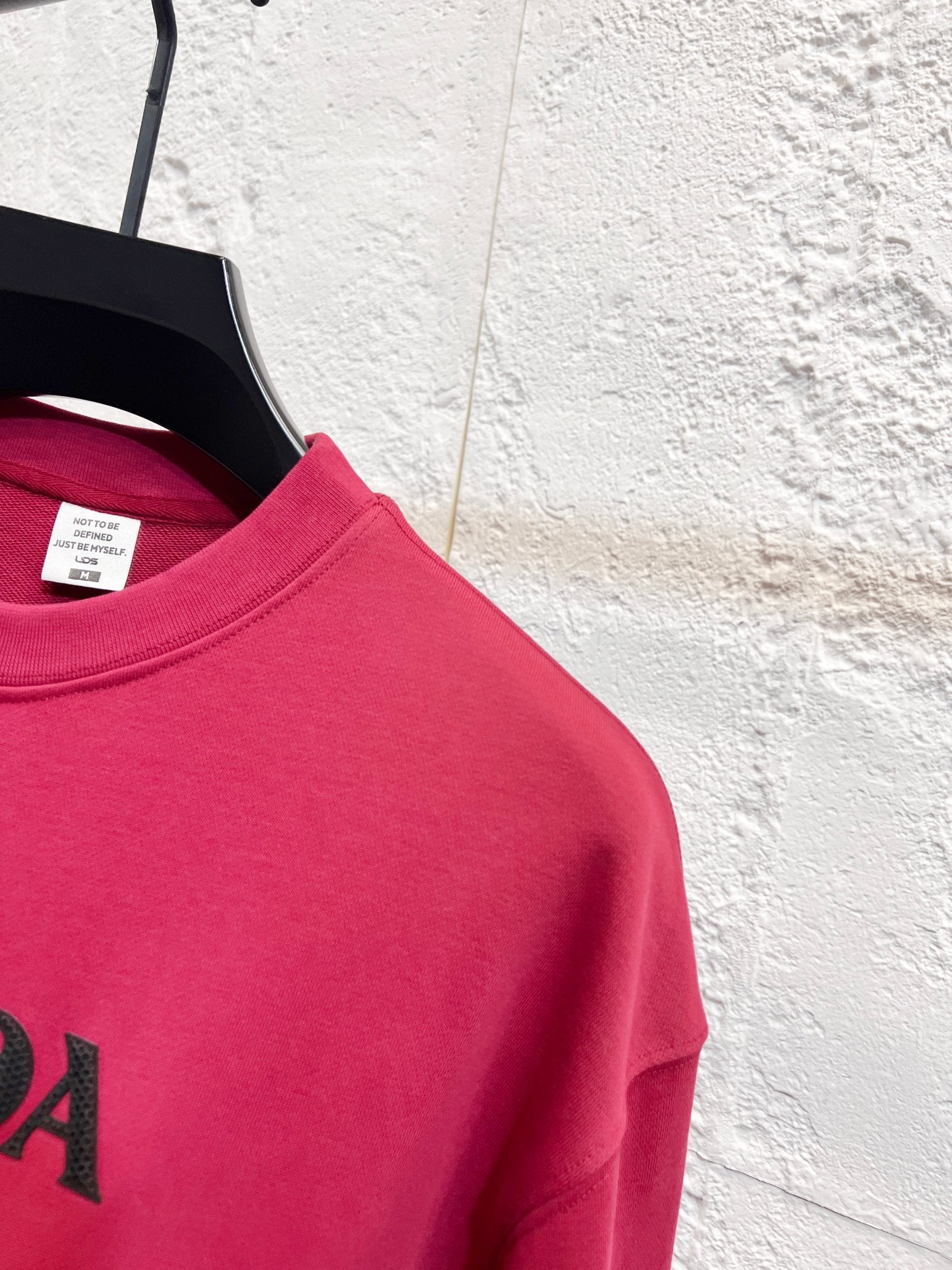 Pink long-sleeve sweatshirt with partial PRADA logo on chest
