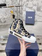 Dior unisex high-top sneaker in blue and beige canvas with black laces, in hand