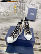 Dior unisex high-top sneakers in blue and beige with black laces, angled pair