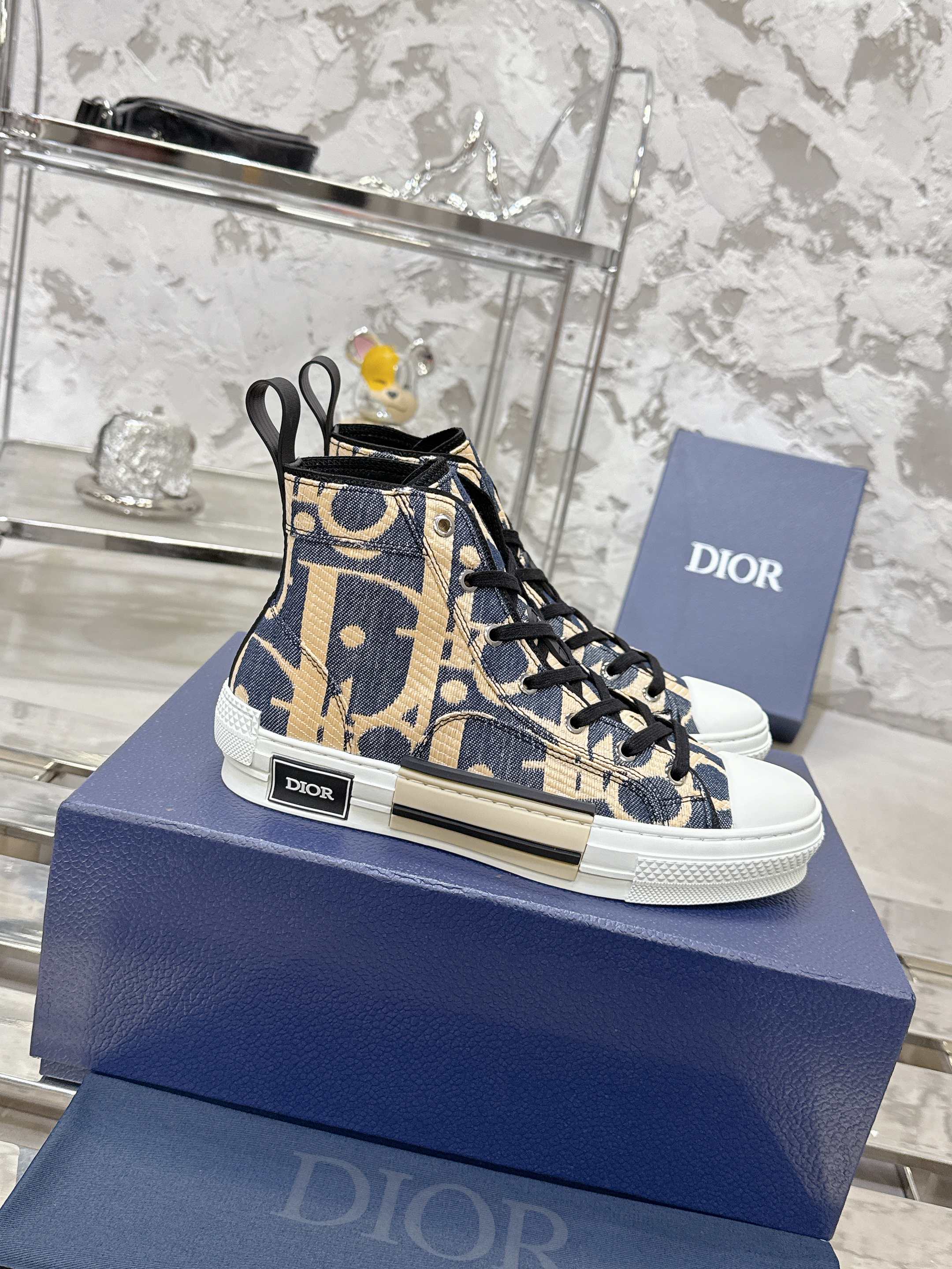 Dior unisex high-top sneakers in blue and beige with black laces, side view