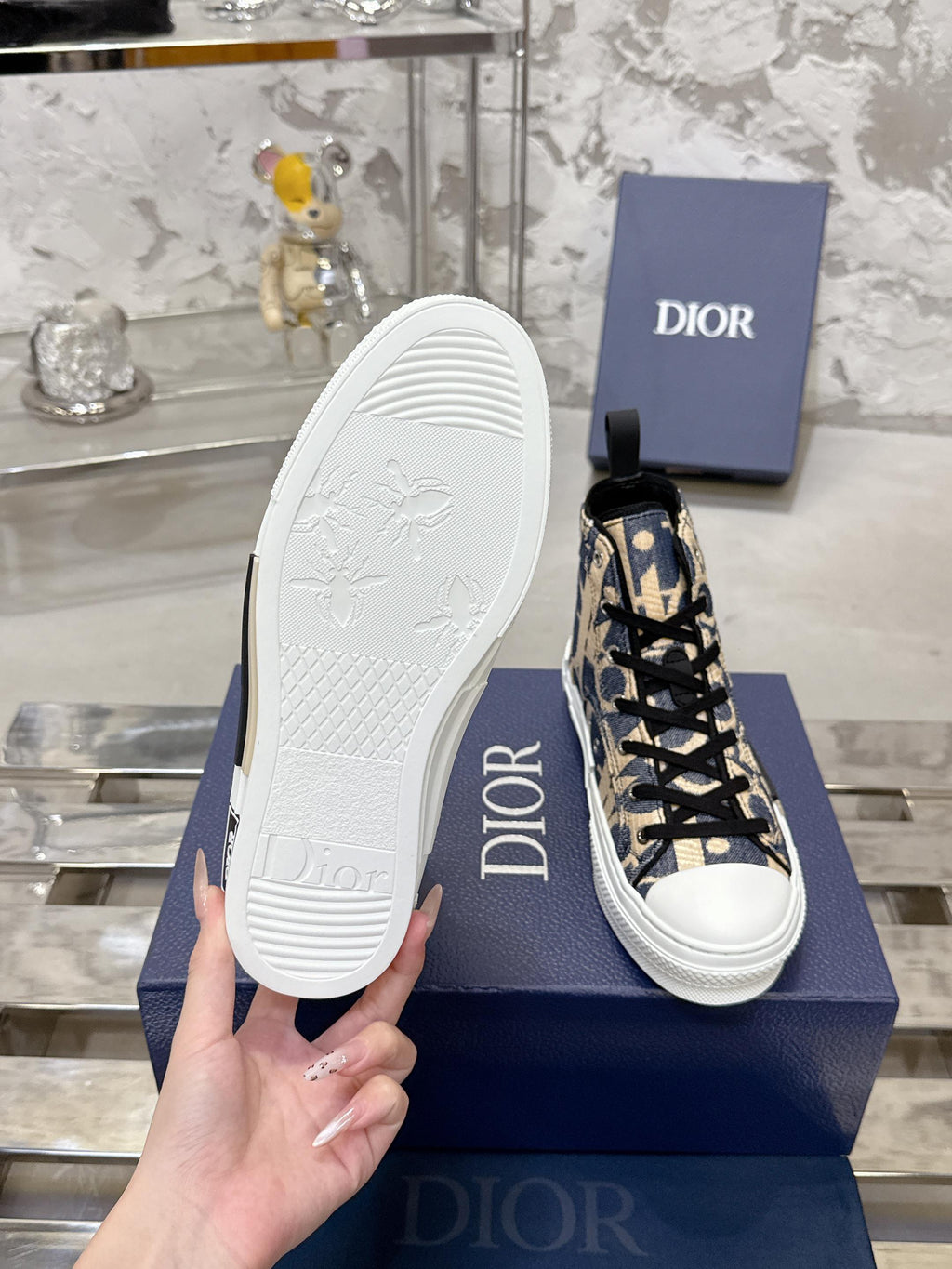 Dior unisex high-top sneaker with white sole shown, blue and beige upper