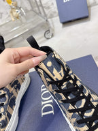 Dior unisex high-top sneaker close-up of patterned upper with black laces