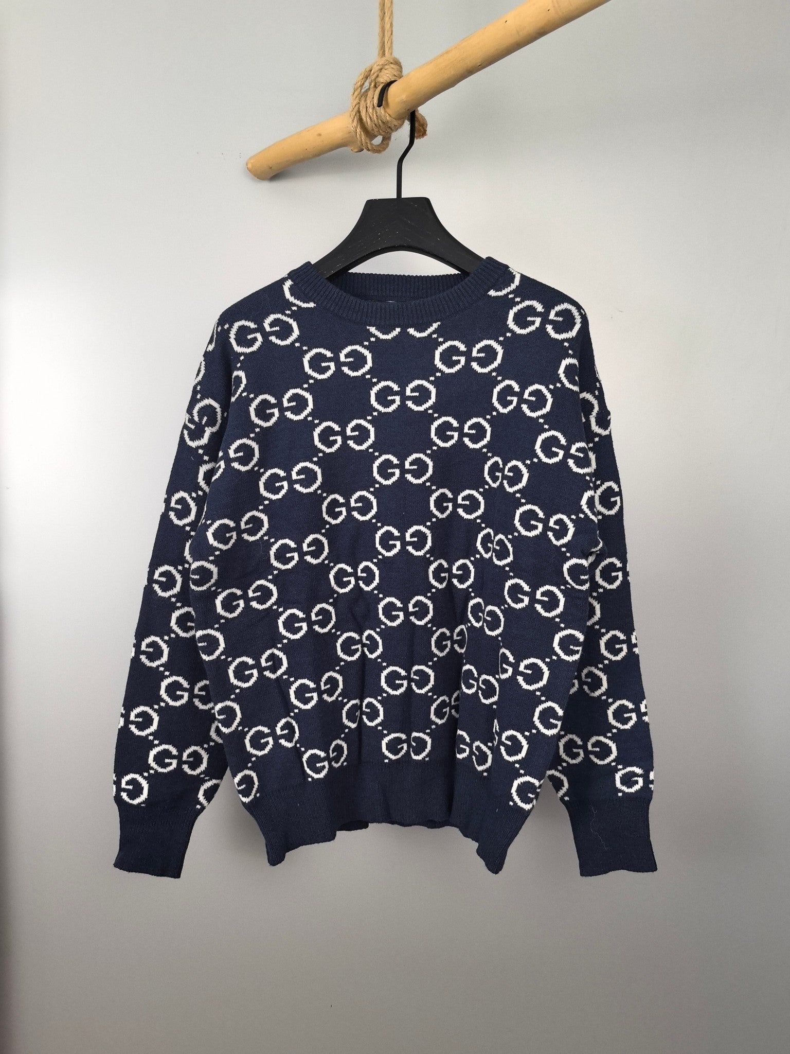 Navy knitted sweater with repeating GG logo pattern, crew neck and long sleeves