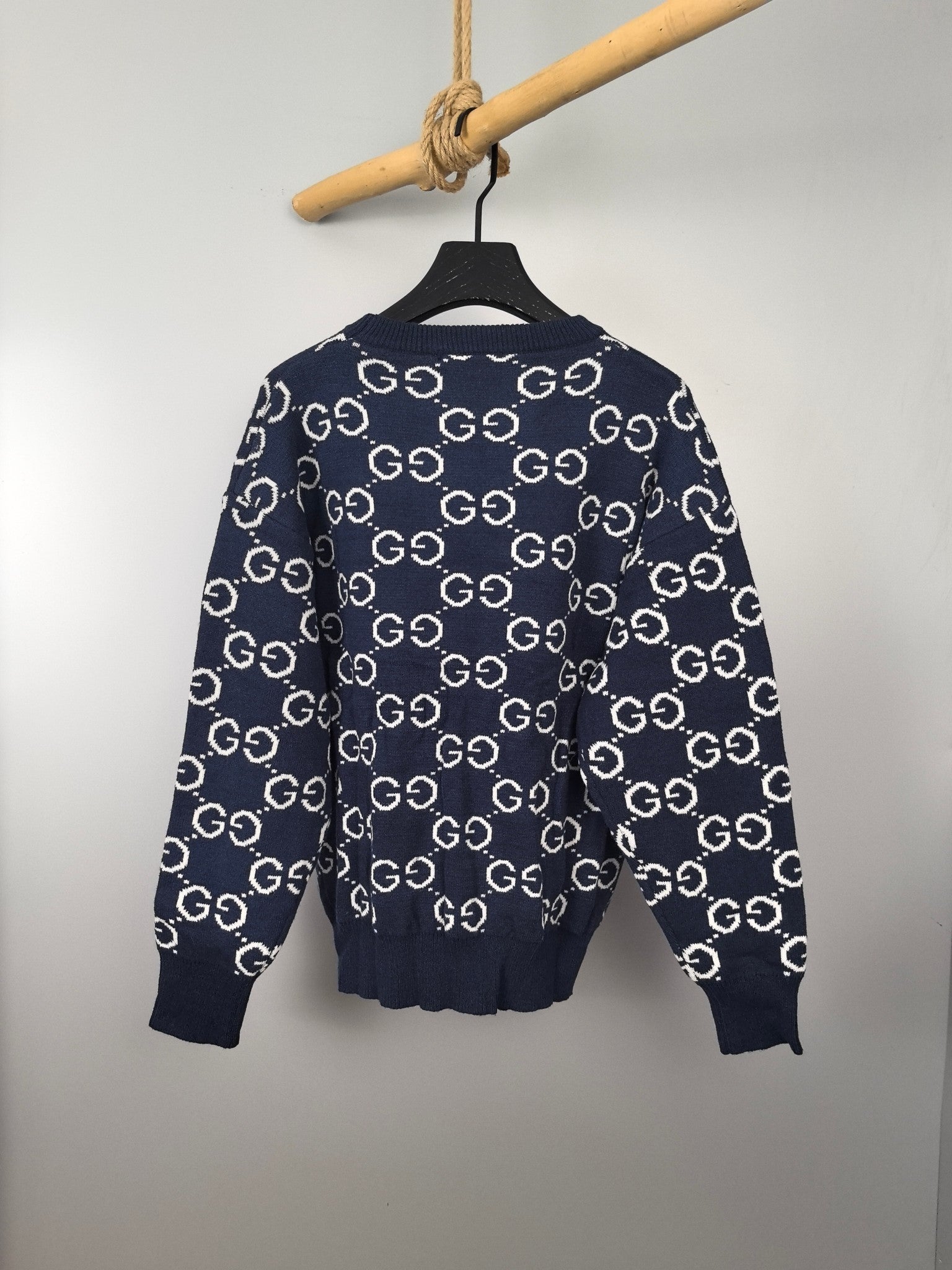 Navy knitted sweater with white GG logo all-over pattern, ribbed cuffs and hem