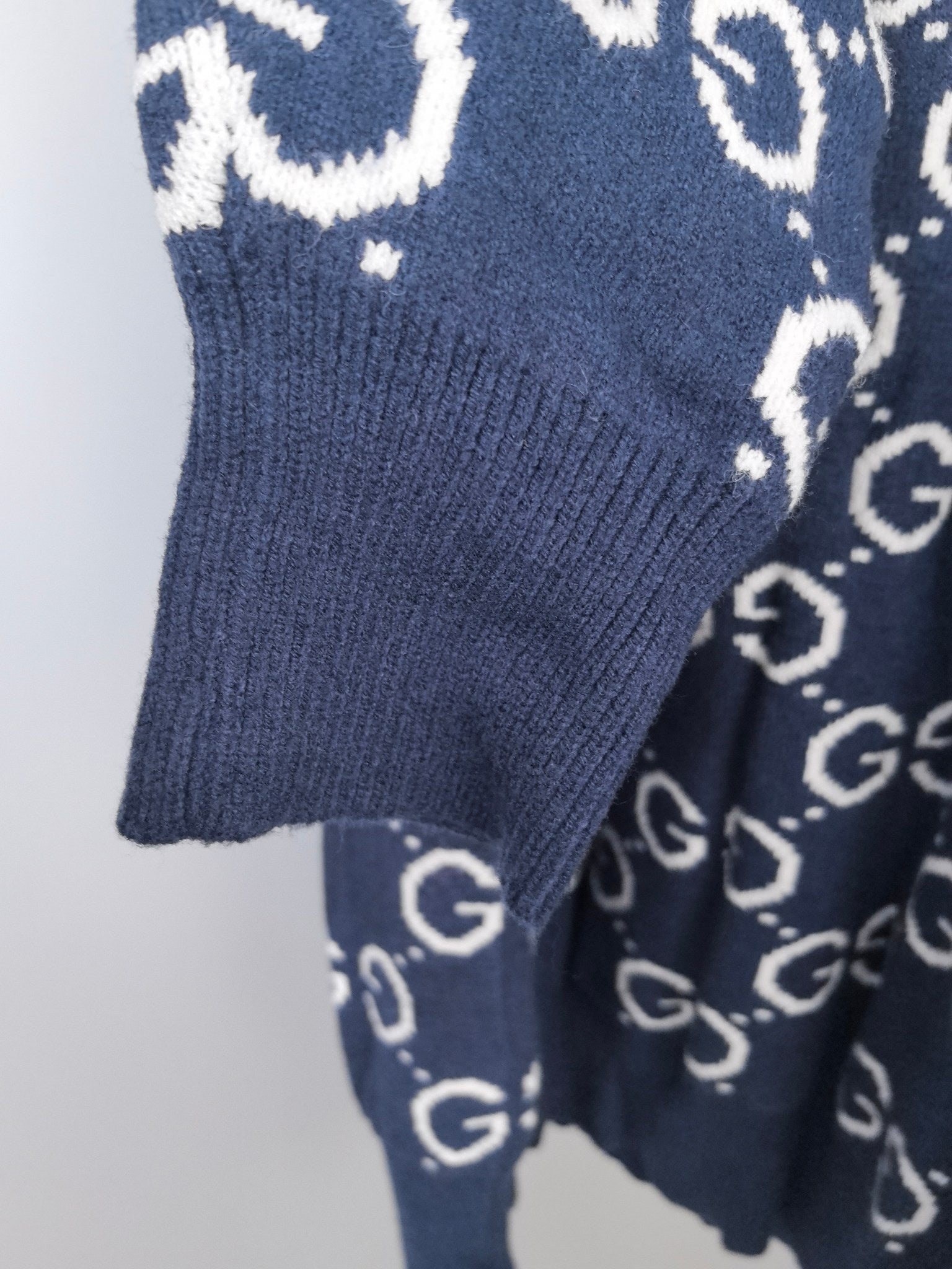 Navy ribbed knit sweater hem and sleeve with GG logo pattern