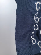 Navy knit sweater sleeve detail with ribbed texture and GG pattern
