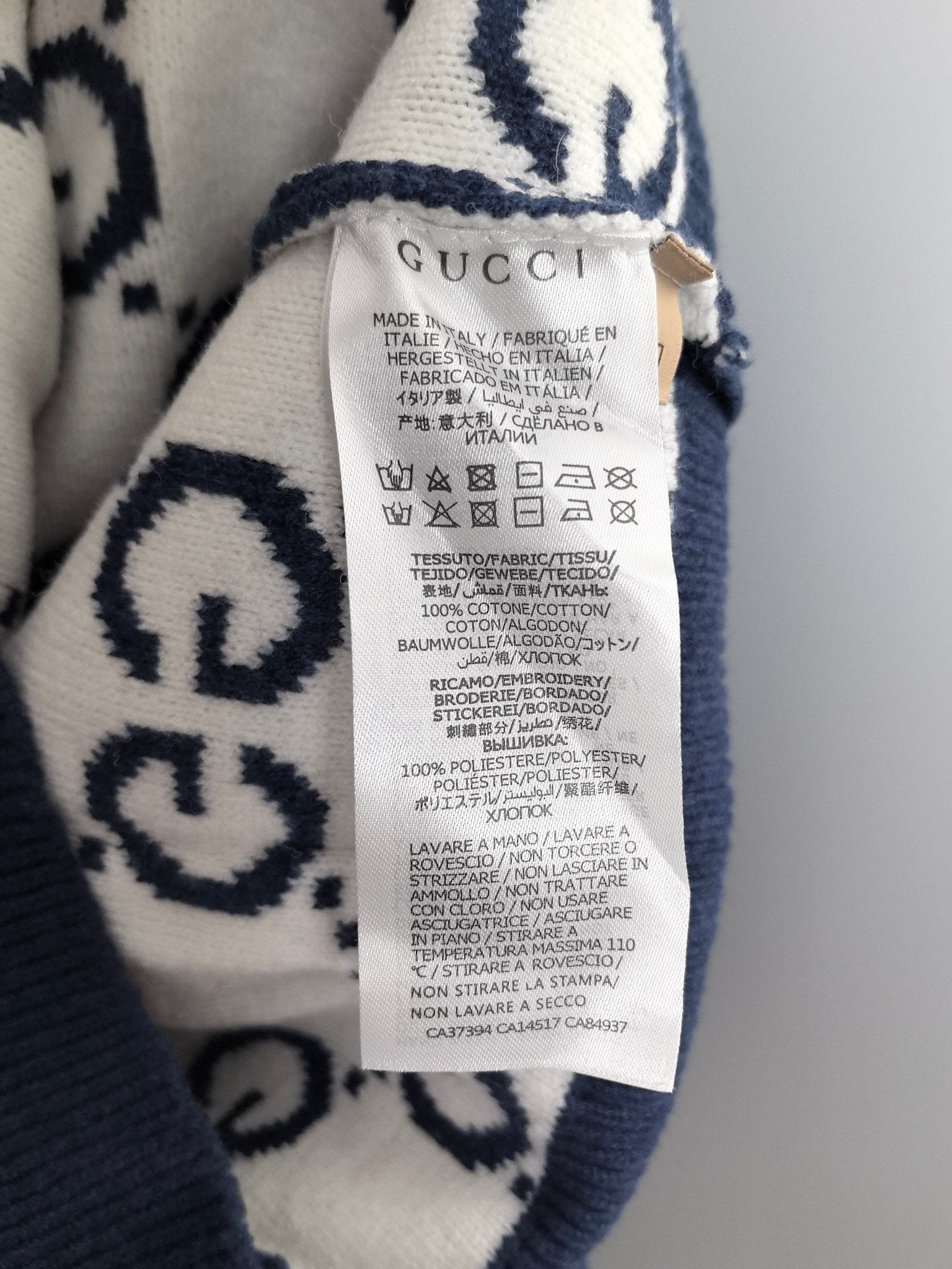 Gucci care label on navy knitted sweater interior collar