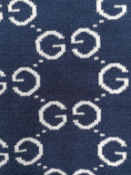 Navy knitted sweater close-up of repeating GG logo pattern