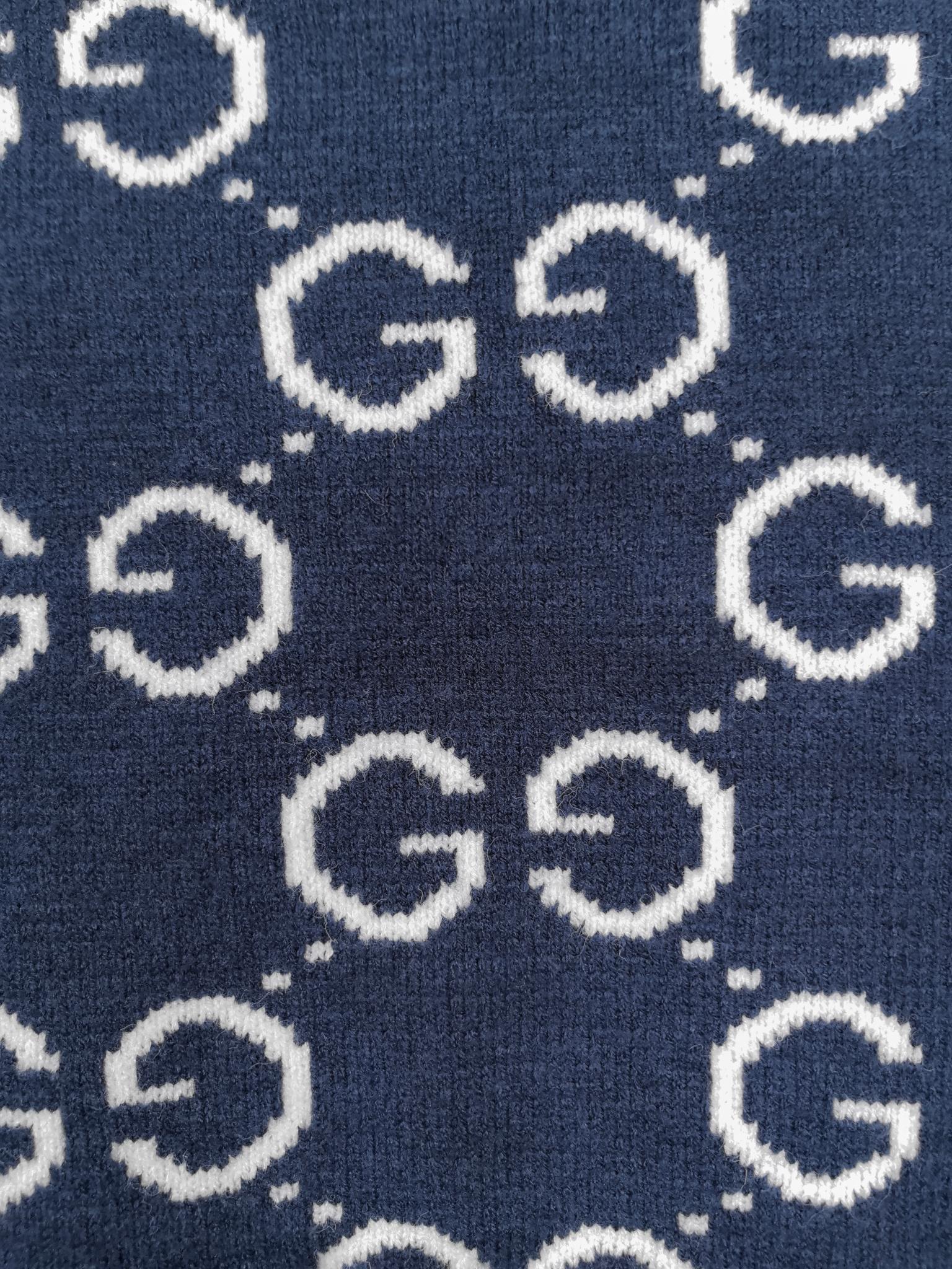 Navy knitted sweater close-up of repeating GG logo pattern