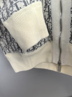 Close-up of off-white ribbed sleeve cuff and zipper on monogram hoodie