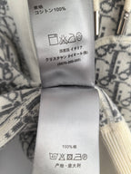 White fabric care label with washing icons and fiber content on hoodie