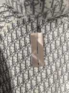 Monogram hoodie with hanging paper tag attached to the fabric