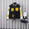 Black varsity jacket with white sleeves, yellow graphic patches, and snap-button front.