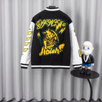 Back varsity jacket with large yellow cat graphic and green outline lettering.