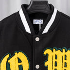 Black varsity jacket collar with white trim and yellow letter patches on front.