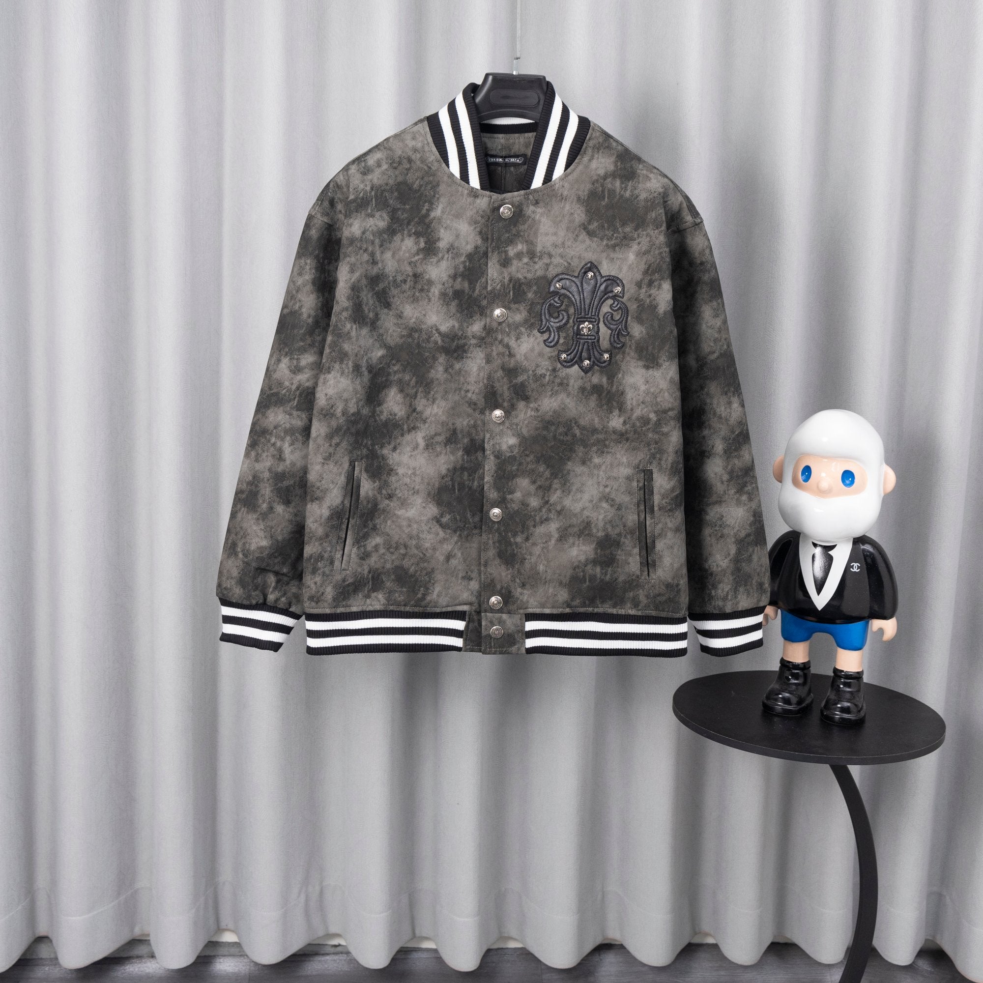 Long-sleeve jacket in dark gray with button front and black-and-white striped cuffs