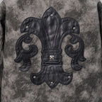 Close-up of dark gray jacket front with black embroidered fleur-de-lis emblem