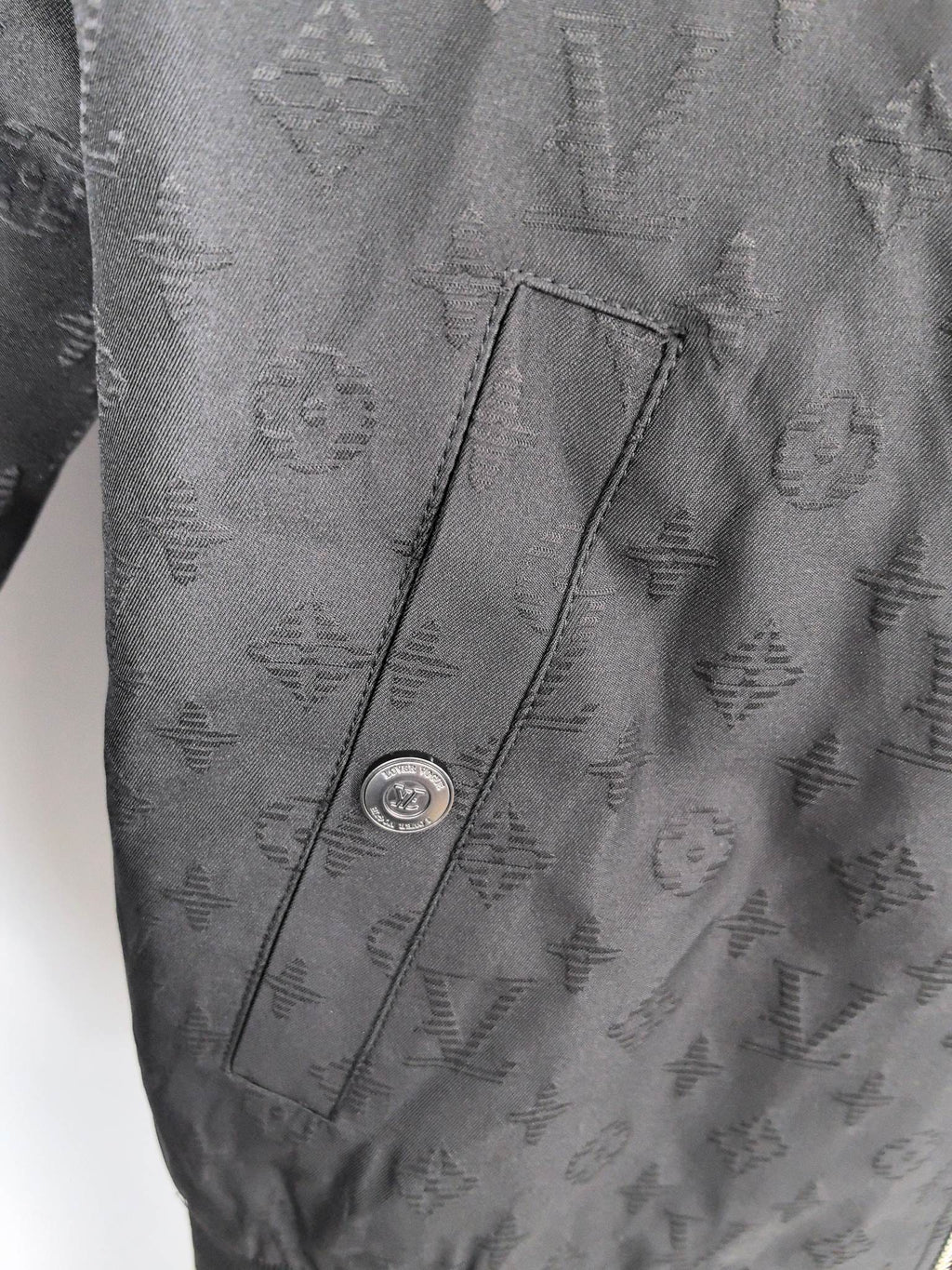 Louis Vuitton monogram zip jacket pocket detail with snap and stitch seam