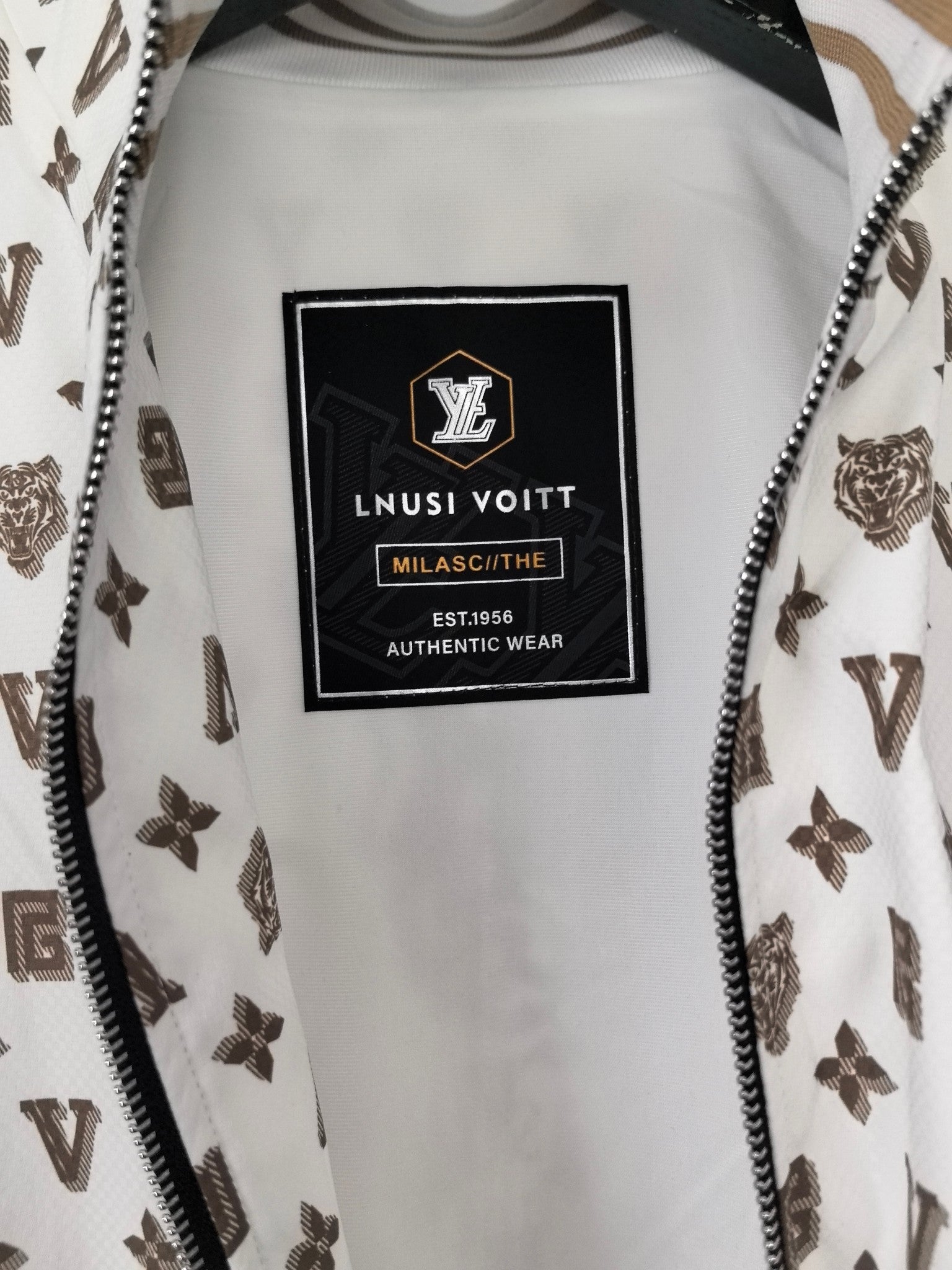 White jacket interior with rectangular brand label and small text on garment lining.