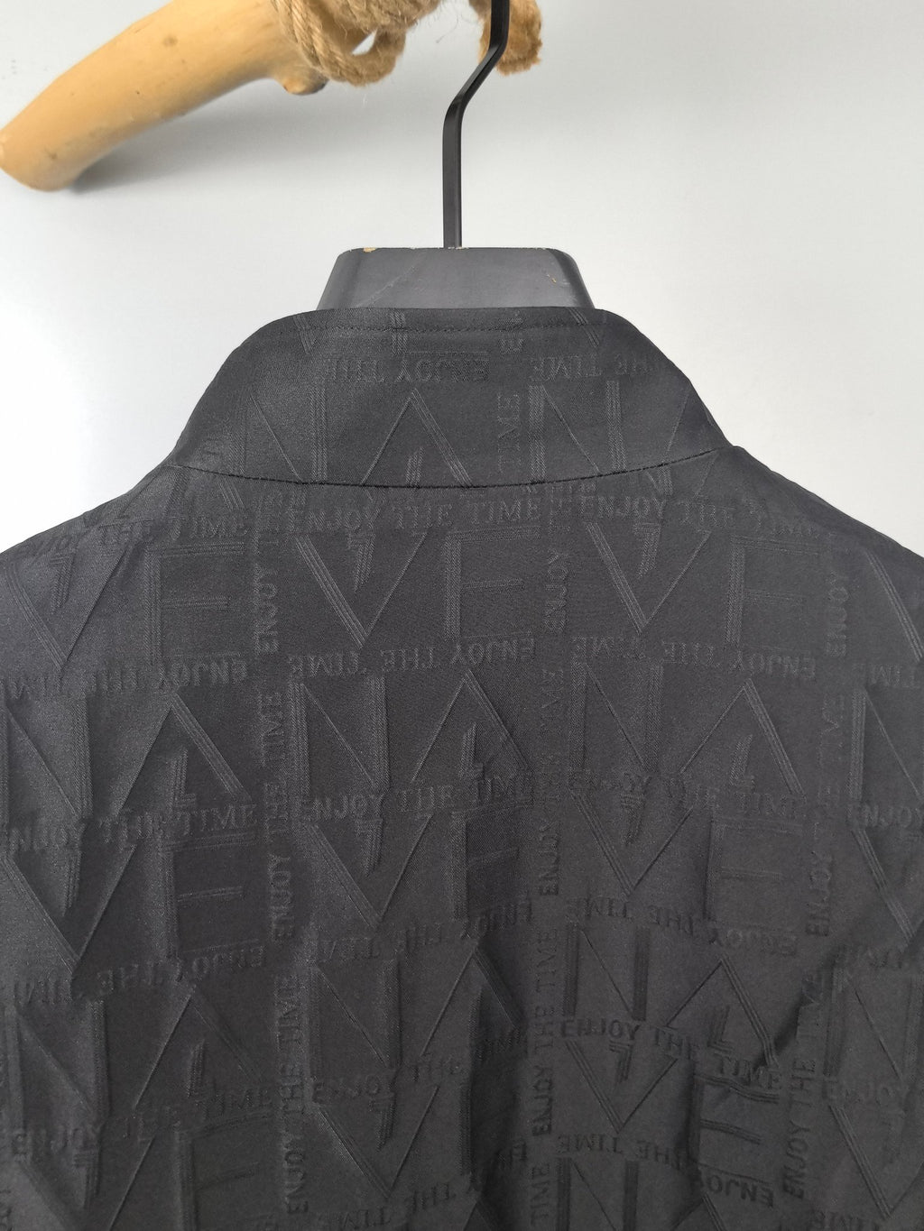 Dior long jacket back close-up, textured geometric pattern under the collar yoke