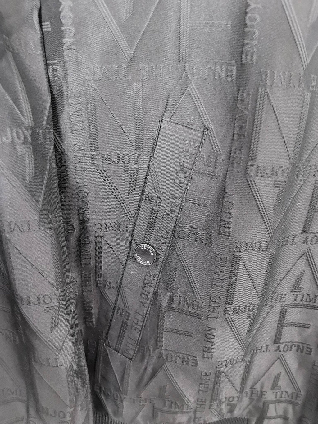 Dior long jacket interior lining close-up with embossed geometric pattern
