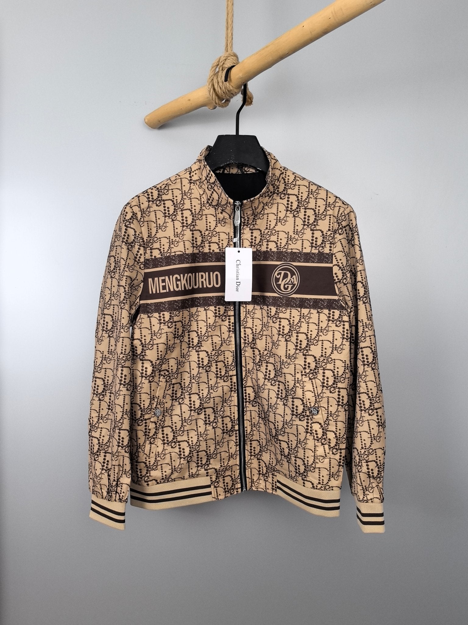 Beige long zip jacket with dark stripe, stand collar, ribbed cuffs on hanger