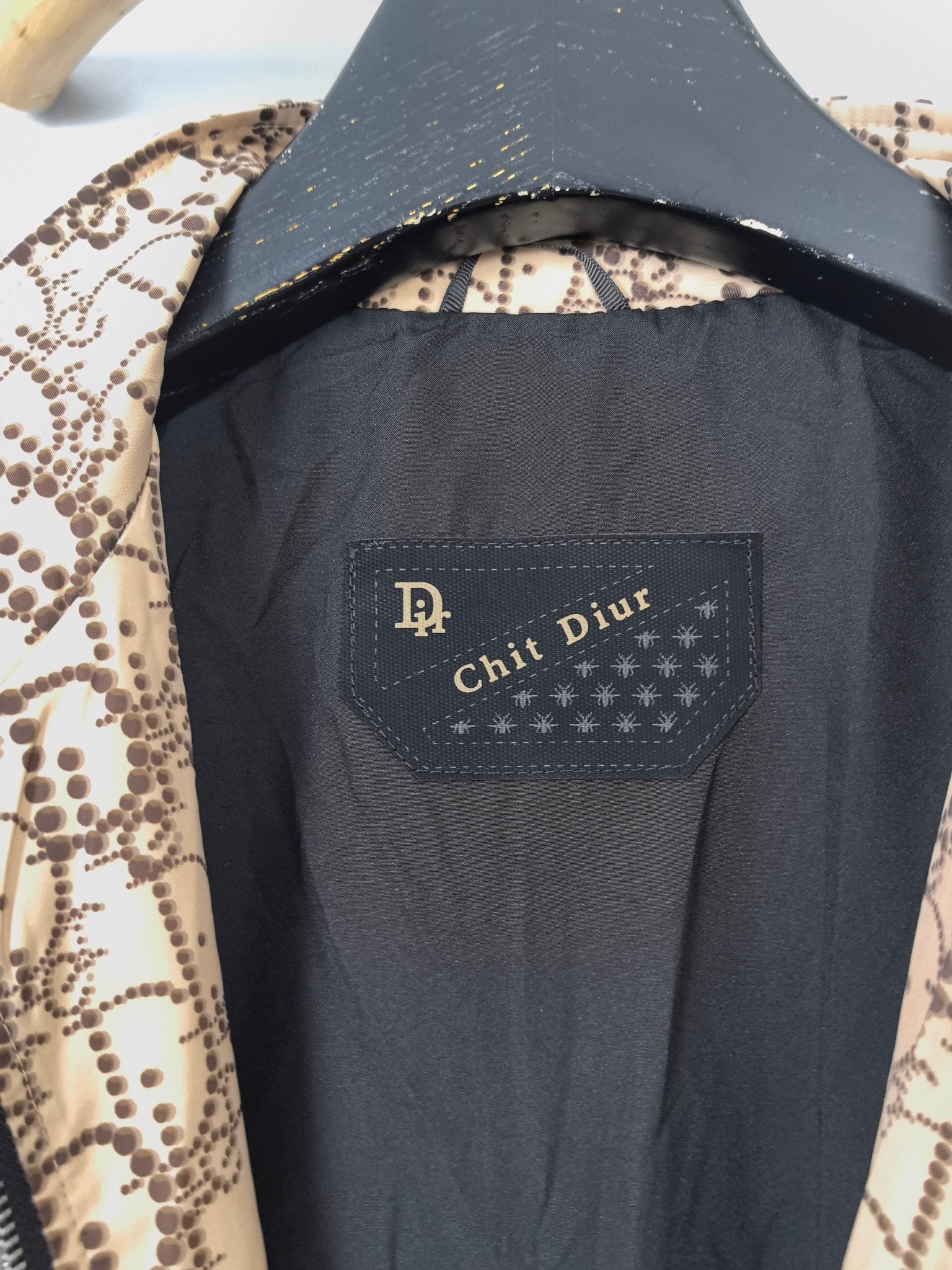Dark interior lining with fabric label on long jacket, view from inside
