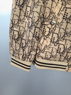 Beige patterned long jacket with ribbed cuffs and hem, partial view