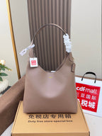 Taupe leather handbag with top handles, shown upright with price tag.