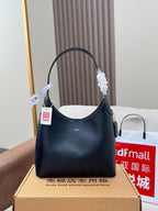 Dark leather handbag with arched top handle and side zipper pocket