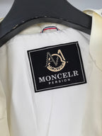 Moncler brand label on off-white hooded jacket interior