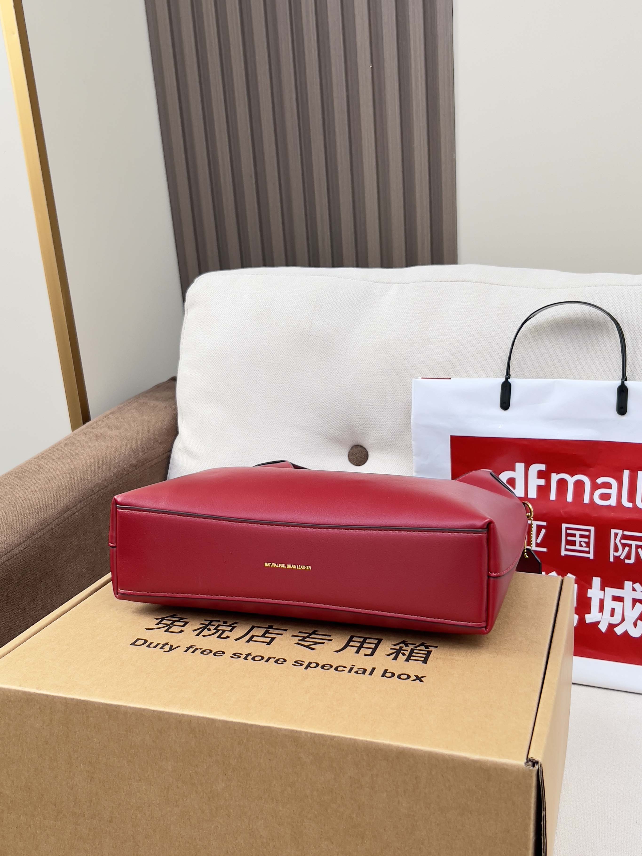 Red leather small bag on a box, with top handle