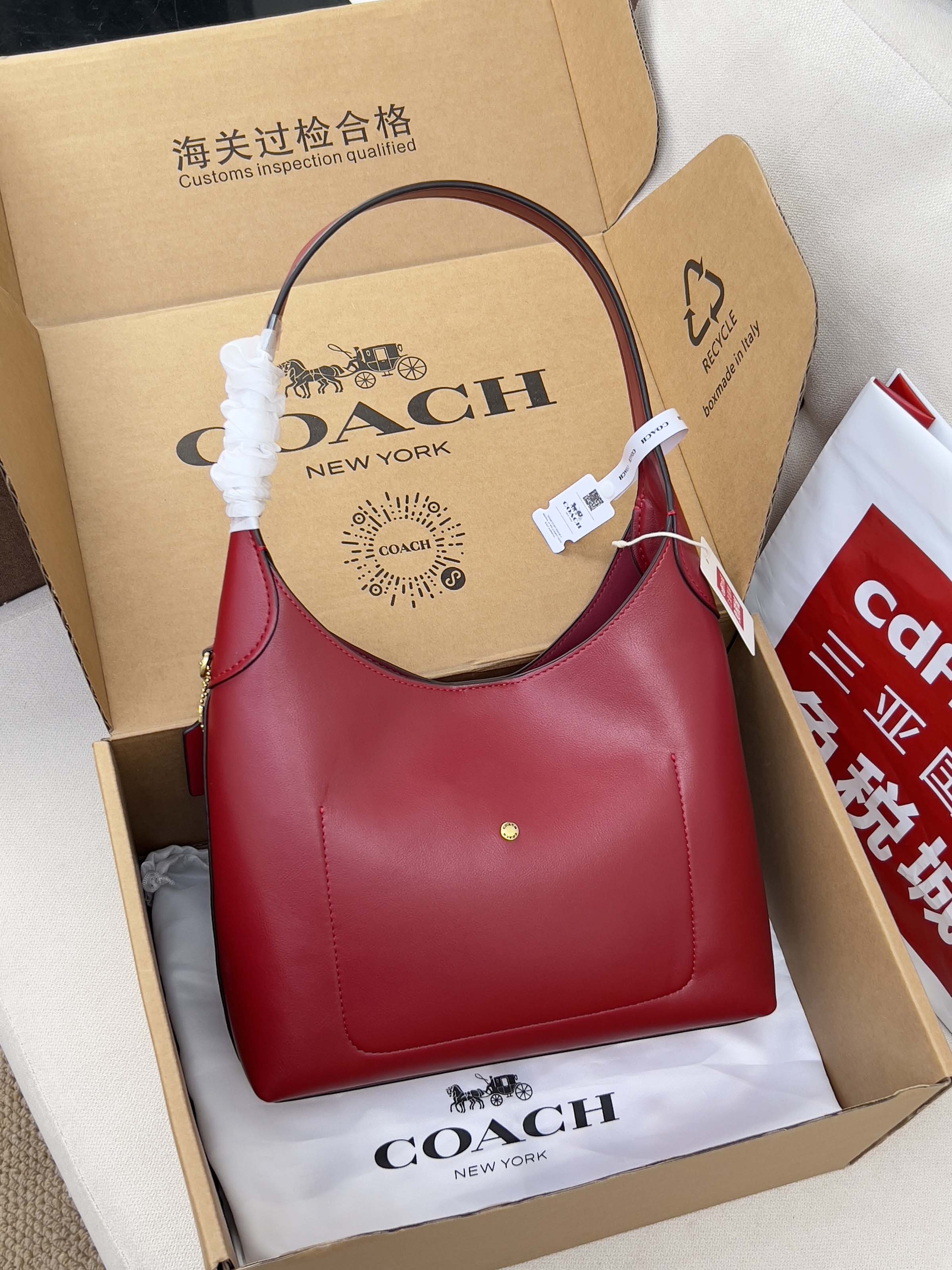 Red leather shoulder bag with top handle and small gold hardware
