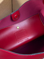 Red leather bag interior label and snap strap detail