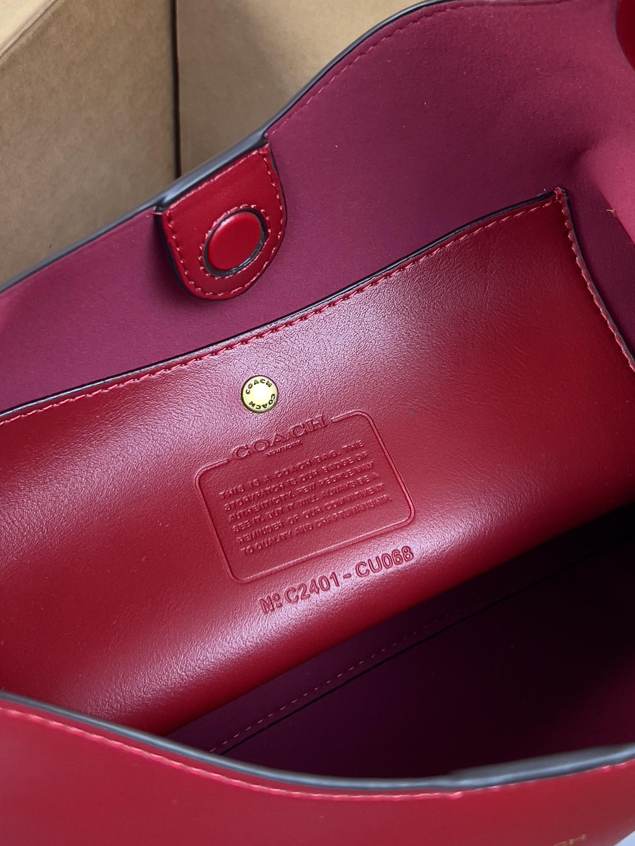 Red leather bag interior label and snap strap detail