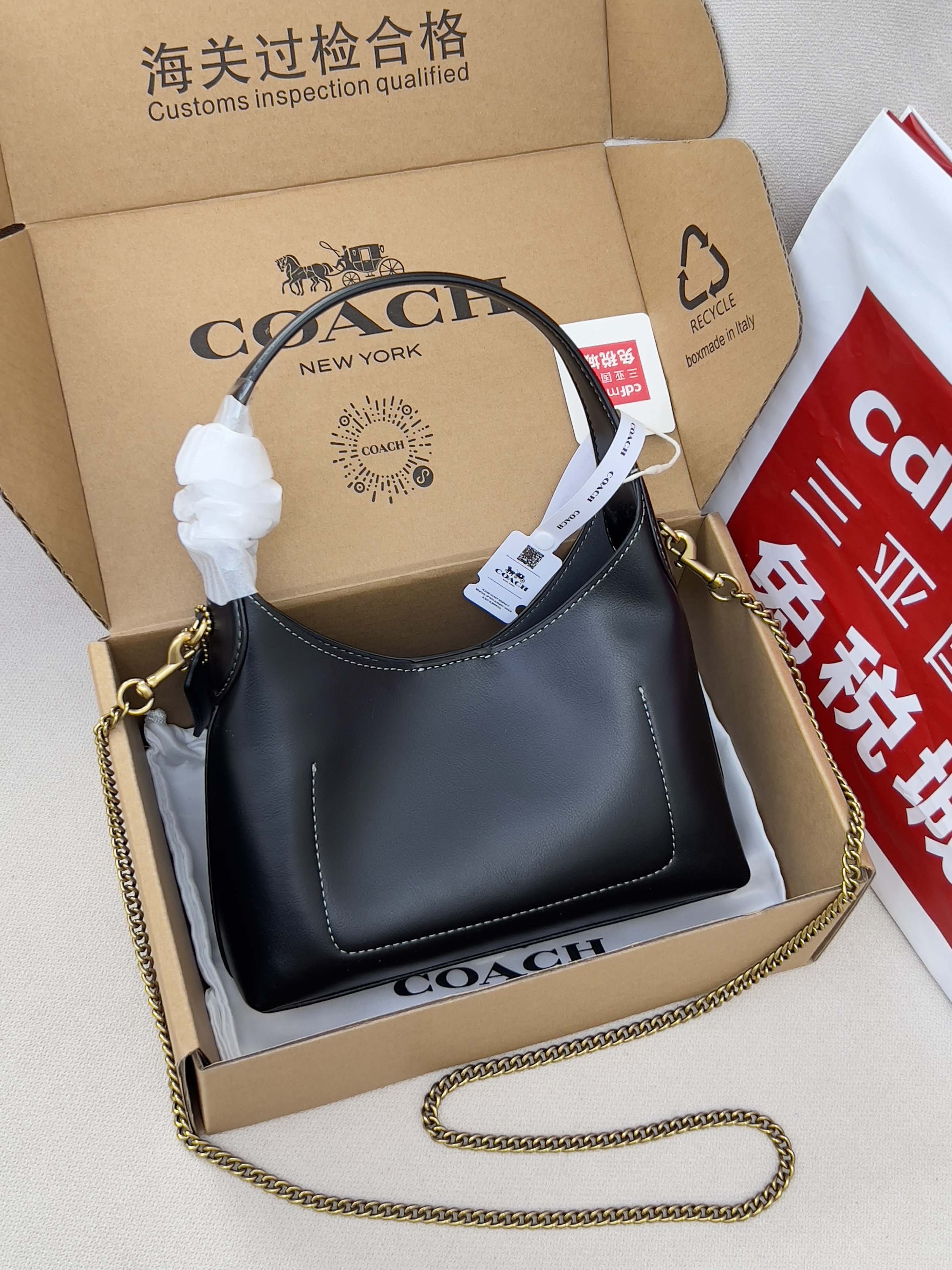 COACH navy leather shoulder bag with gold chain strap, shown in box