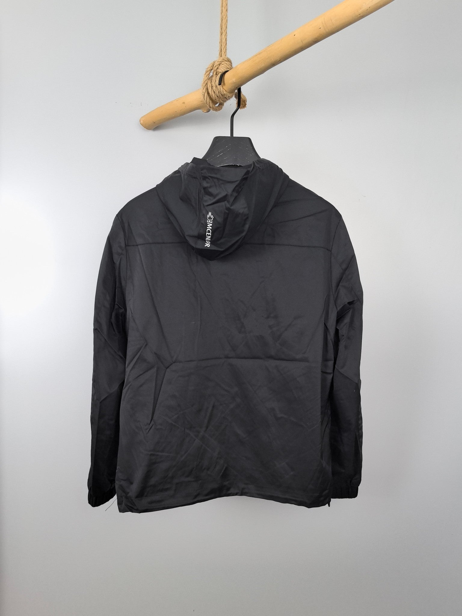 Black long hooded jacket with drawstring neckline and front half-zip.