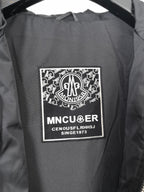 Black hooded jacket inner brand label patch on lining.