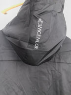 Black long jacket back with large white MONCLER logo print.