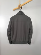 Prada zip-up jacket back view, dark gray with ribbed hem and long sleeves
