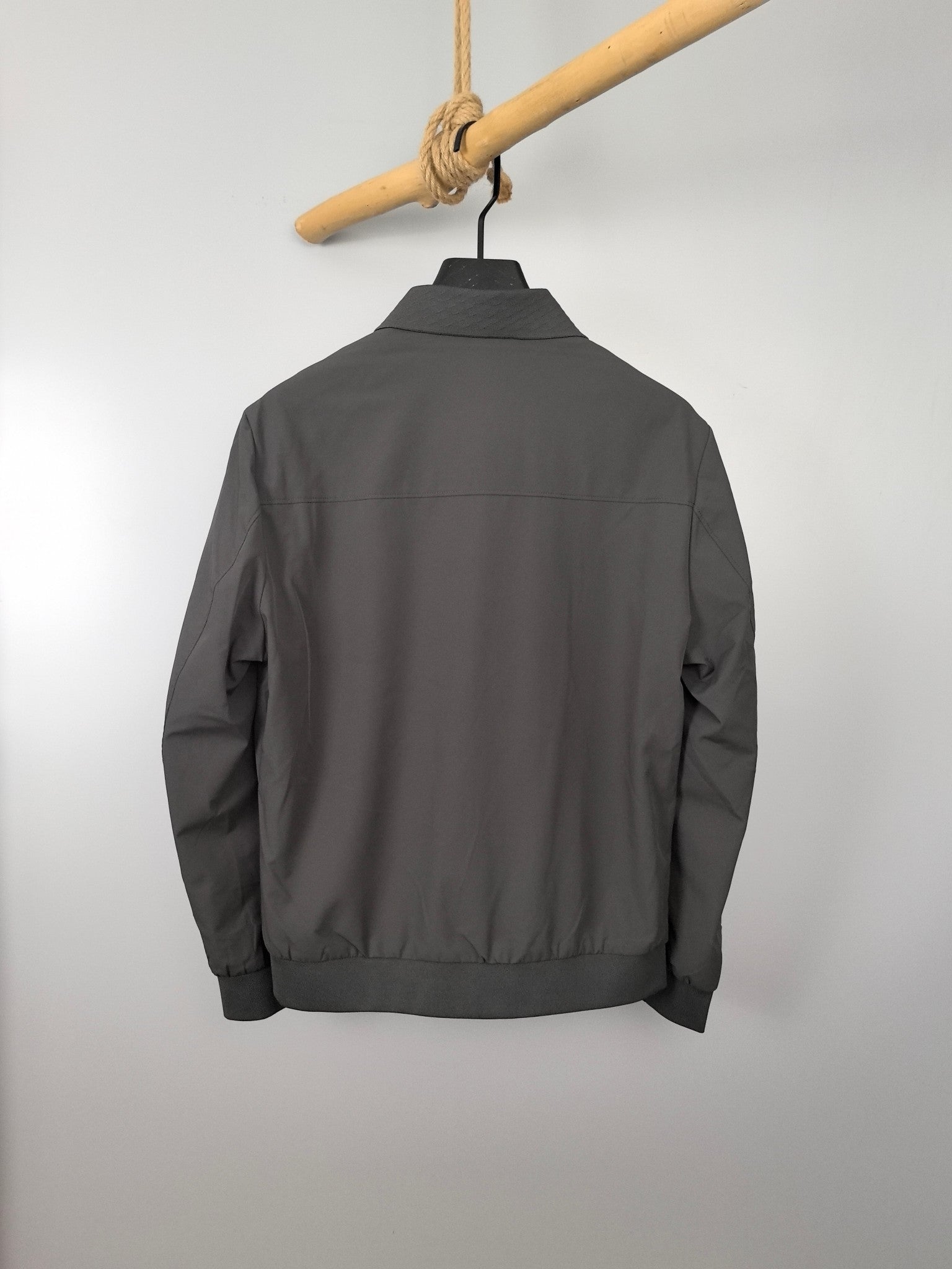 Prada zip-up jacket back view, dark gray with ribbed hem and long sleeves