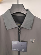Prada jacket close-up at collar and zipper, dark gray with hanging logo tag