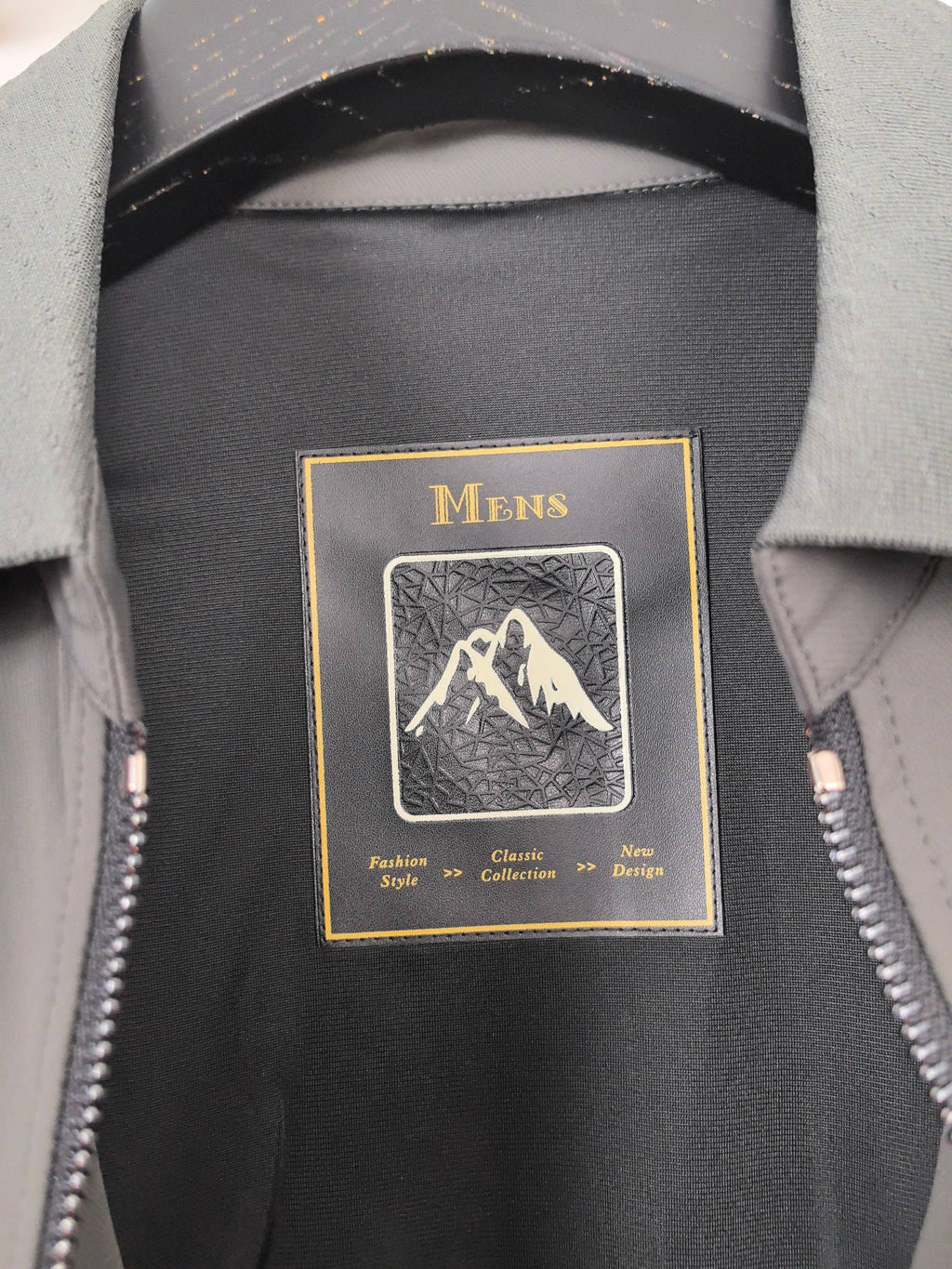 Prada jacket interior label reading Mens with mountain graphic on dark lining