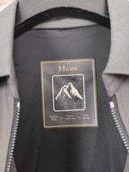 Prada jacket interior label reading Mens with mountain graphic on dark lining