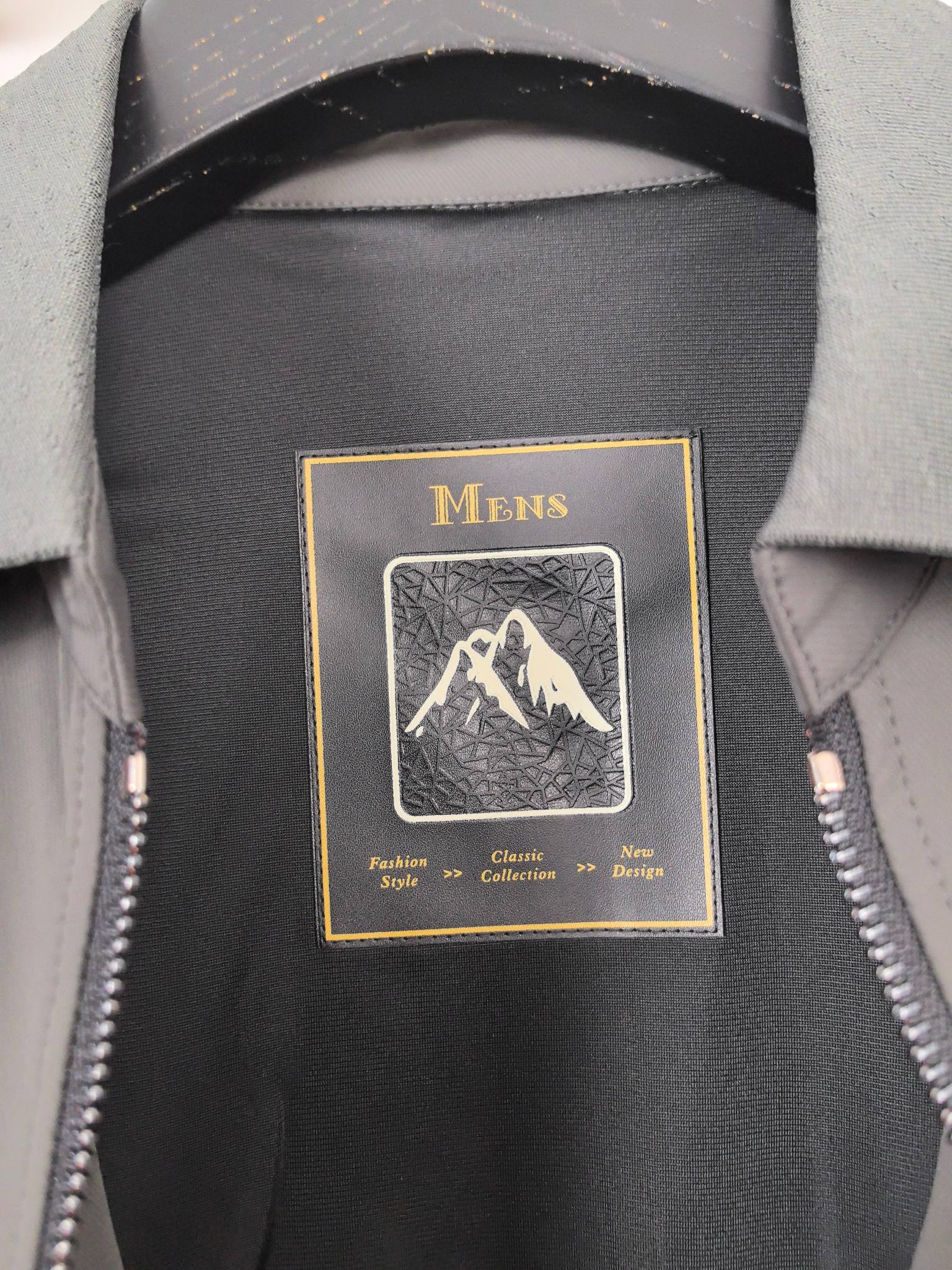 Prada jacket interior label reading Mens with mountain graphic on dark lining