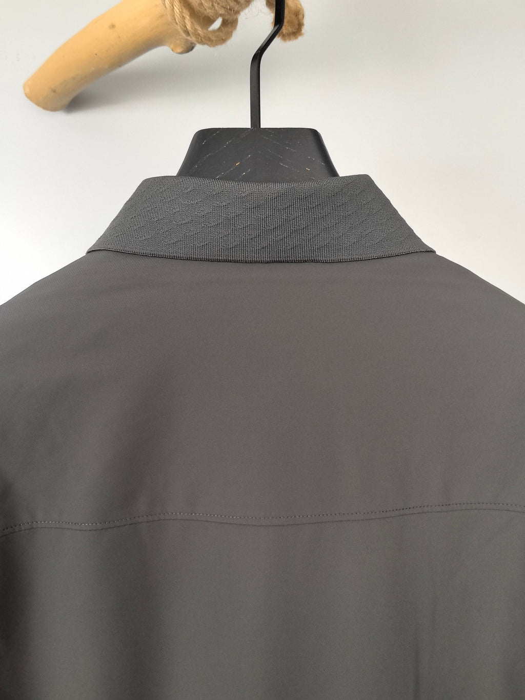 Prada jacket back view with raised collar and dark gray fabric seam detail